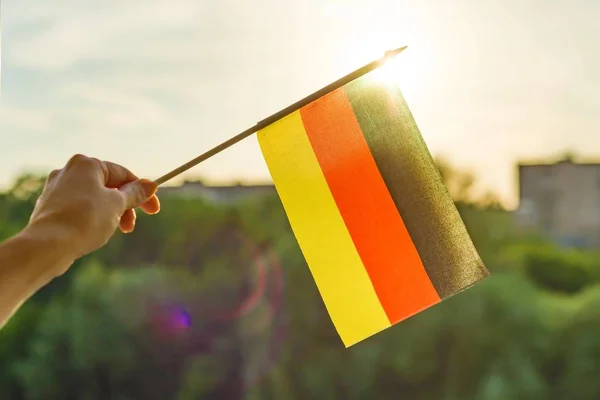 depositphotos_203315038-stock-photo-hand-holds-germany-flag-open.jpg