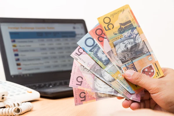 depositphotos_95775166-stock-photo-hand-holding-australian-dollar-in.jpg