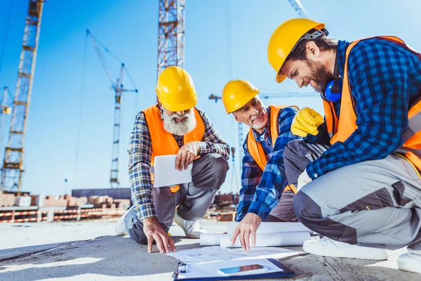 depositphotos_170349218-stock-photo-construction-workers-discussing-building-plans.jpg