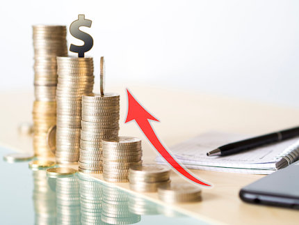 Concept photo showing value increase of dollar. tower made with coins