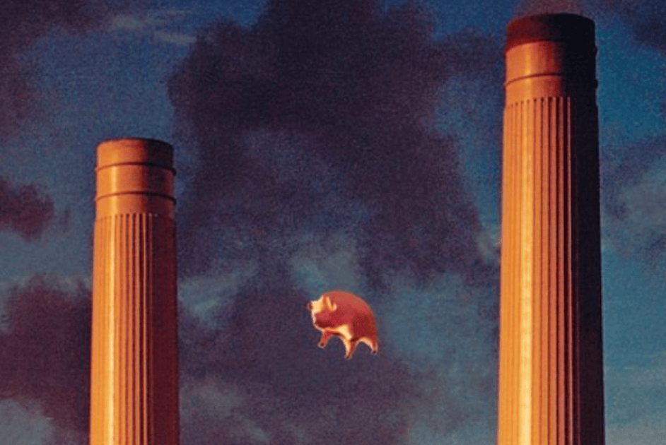 A surreal image depicting a pig flying between two tall smokestacks against a dramatic sky.