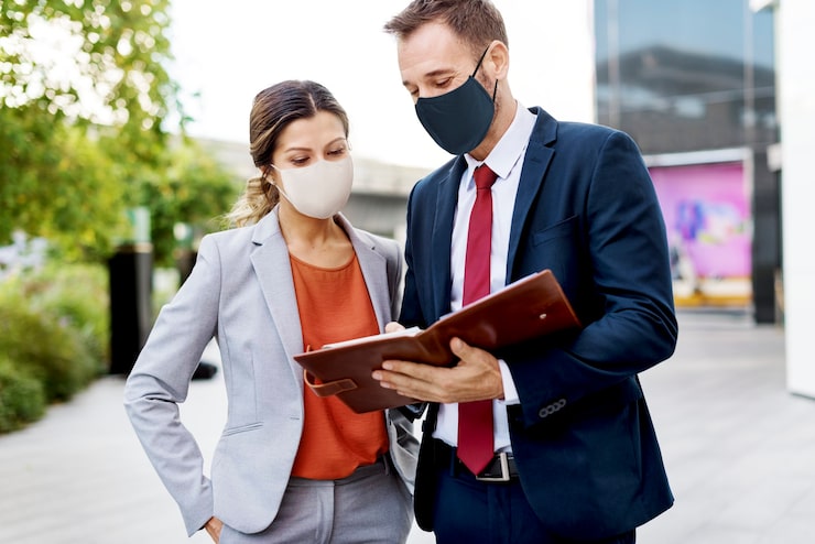 business people in medical masks discussing work plan during coronavirus pandemic