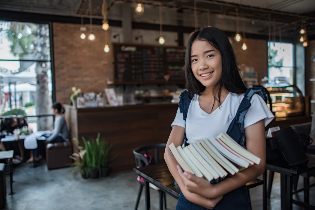 smiling-young-woman-holding-books (1).jpg smiling-young-woman-holding-books (1).jpg