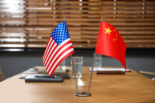 depositphotos_414933954-stock-photo-usa-china-flags-wooden-table.jpg