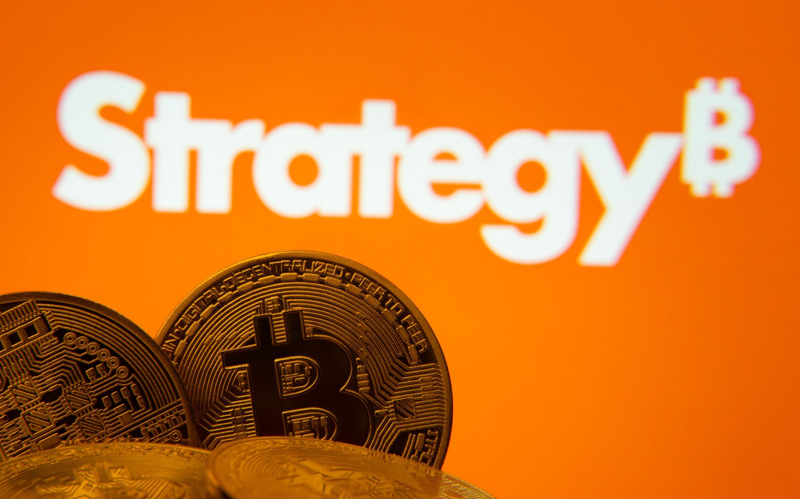 The Strategy logo and concept Bitcoin coins by Bangla press via Shutterstock