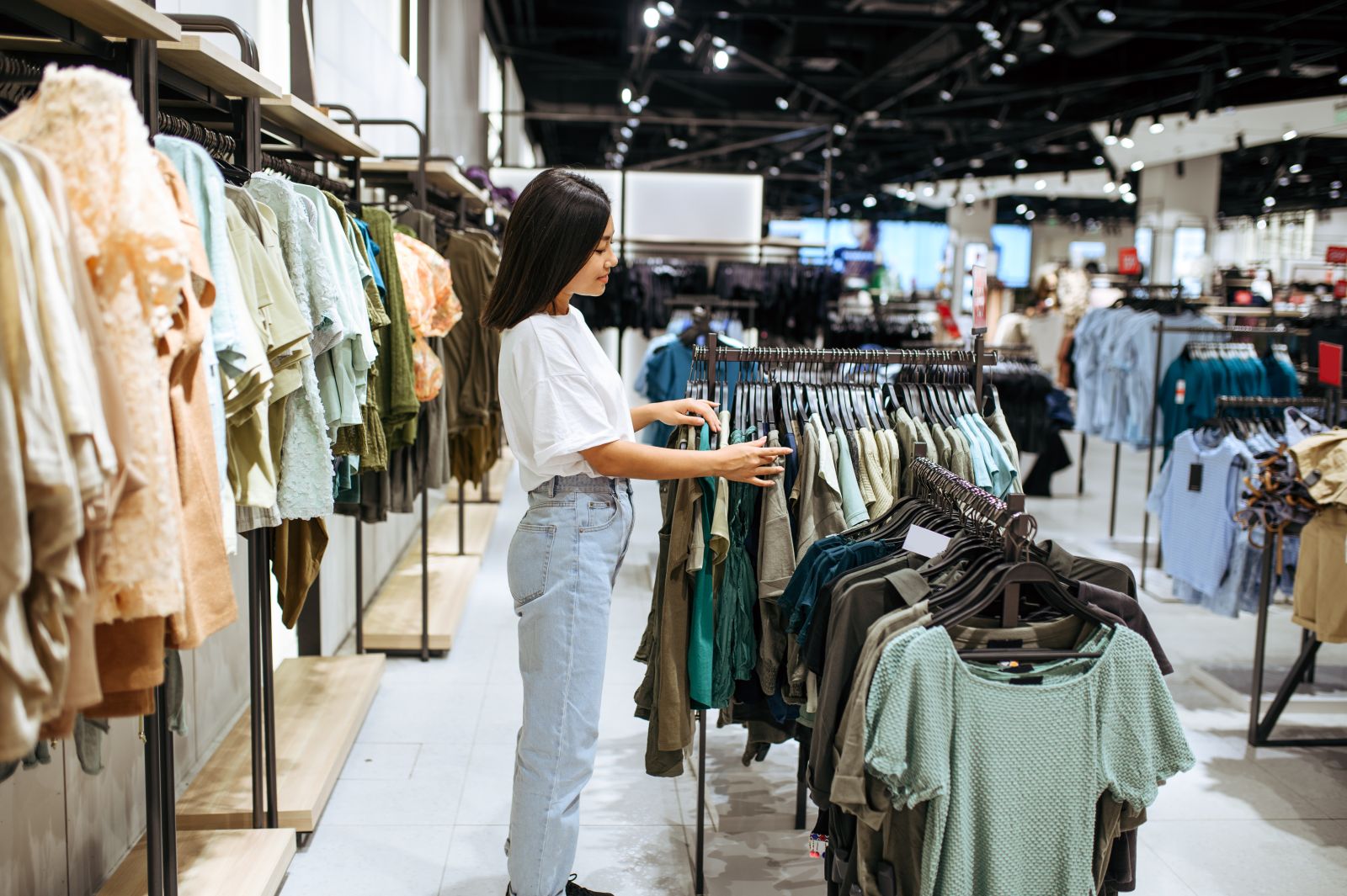 Woman choosing clothes in clothing store by Nomad_Soul via Adobe Stock