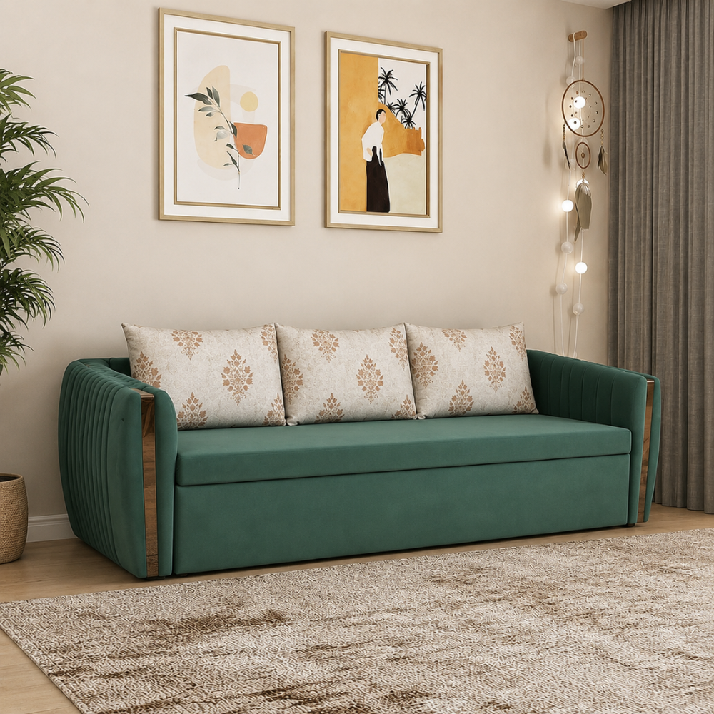 Emerald green velvet 3-seater sofa cum bed with gold accents and channel-tufted sides, styled with beige floral-print cushions in a modern living room